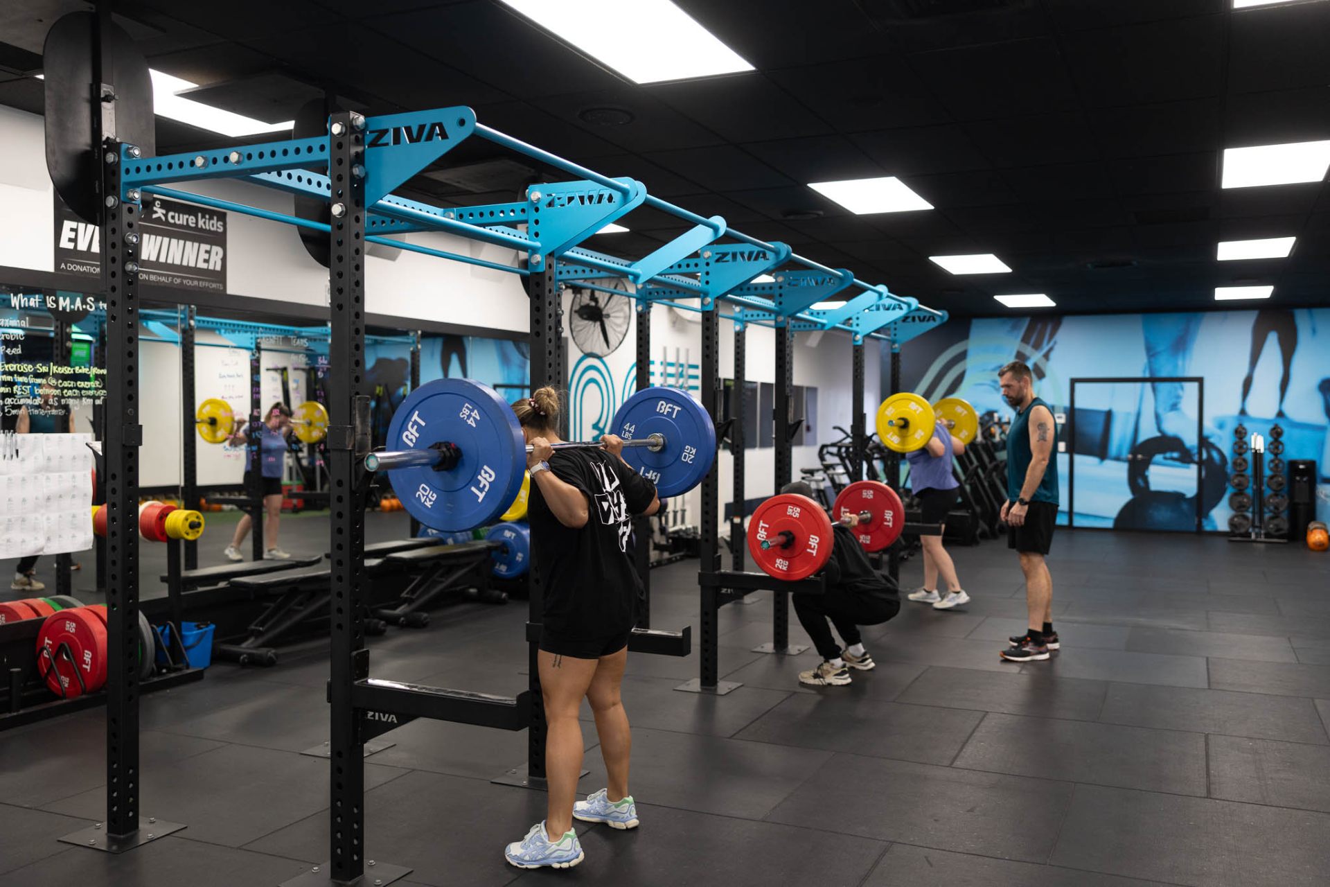 BFT members back-squatting under coach supervision